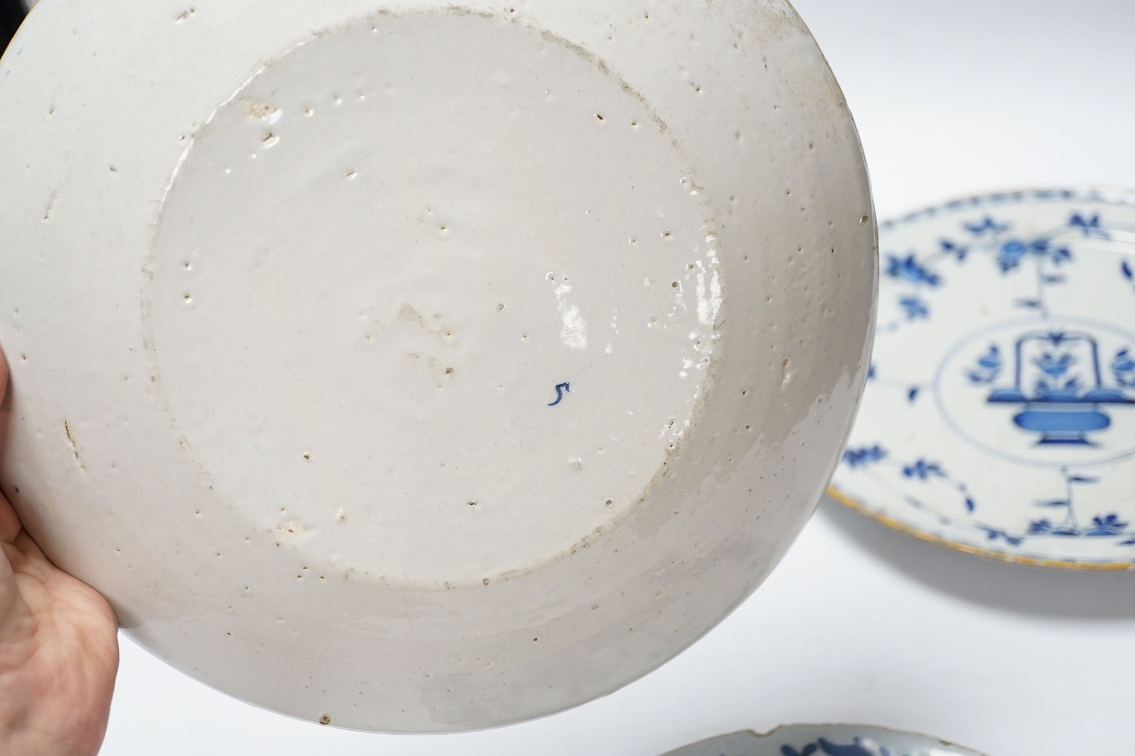 A pair of late 18th century Delft plates and an English delftware plate (3)